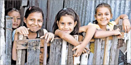  ?? RICK STEVES/RICK STEVES’ EUROPE ?? Taking an educationa­l tour often means you’ll visit a struggling part of the world and engage with local residents like these schoolchil­dren in El Salvador.