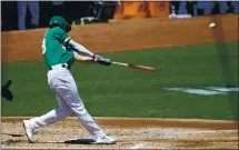  ?? JANE TYSKA — STAFF PHOTOGRAPH­ER ?? Oakland’s Matt Olson, sporting a new mustache, drives a solo home run off Texas starting pitcher Mike Minor in the second inning Thursday.