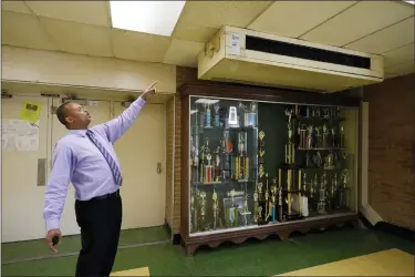  ?? ROGELIO V. SOLIS — THE ASSOCIATED PRESS ?? Jim Hill High School principal Bobby Brown, points out one of the outdated air-condition units that are installed throughout the Jackson, Miss., school, Jan. 12.