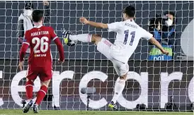  ??  ?? MADRID MAGIC Asensio, left, slams second goal for Real after Vinicius had opened the scoring