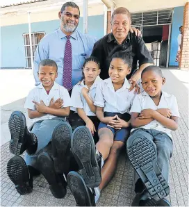  ?? Picture: WERNER HILLS ?? SHOE DONATION: Little Slipper donated hundreds of pairs of school shoes to the pupils of Bayview Primary School in Helenvale. Pupils, from left, Denver Freeman, 9, Michelle Muller, 10, Mickayla Koeberg, 10, and Keethan Damons, 6 try on their new shoes...