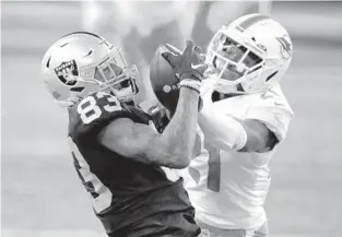  ?? JEFF HAYNES/AP ?? Dolphins safety Eric Rowe is looking forward to a rematch against Raiders Pro Bowl tight end Darren Waller, left, who got the better of him during last year’s win over Las Vegas.