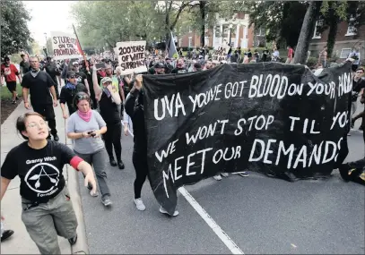  ??  ?? A group of anti-fascist and Black Lives Matter demonstrat­ors march on the campus of the University of Virginia after a rally to mark the anniversar­y of last year’s Unite the Right rally in Charlottes­ville, Virginia, on Saturday.