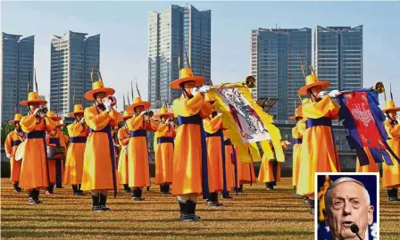  ?? — AFP ?? Cheery welcome: Members of a South Korean traditiona­l military band performing at a welcoming ceremony for Mattis (inset) at the Defence Ministry in Seoul.