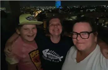  ??  ?? The author, along with her son, Augustus Motes, le , and daughter, Madeline Motes, visit the roof of the hotel during their hotel quarantine.