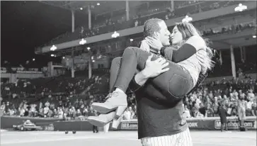  ?? Wally Skalij Los Angeles Times ?? THE CUBS’ ANTHONY RIZZO kisses his girlfriend at Wrigley Field after his team’s 5-0 victory over the Dodgers to clinch the NL pennant. Chicago is enthralled with the Cubs’ return to the World Series.