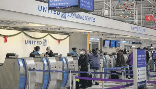  ?? PAT NABONG/SUN-TIMES ?? People at a United Airlines counter at O’Hare Airport last month.