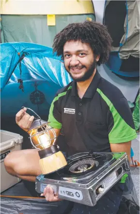  ?? ?? Tentworld Cairns’ Koa Williams with the latest camping accessorie­s to keep you comfortabl­e in the bush. Picture: Brendan Radke