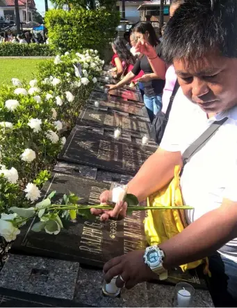  ?? ELMER RECUERDO ?? Painful memories Relatives of victims of super typhoon “Yolanda” gather at the Palo Cathedral compound yesterday to mark the 2013 disaster.