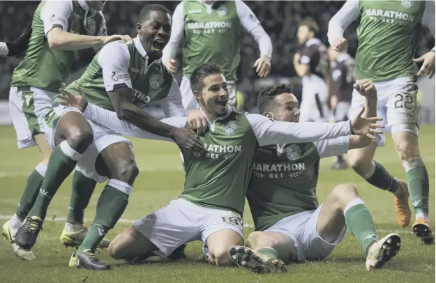  ??  ?? Scorer Jamie Maclaren, centre, celebrates the second goal in his side’s 2-0 win over Hearts at Easter Road last night with John Mcginn, right, and Marvin Bartley, left.