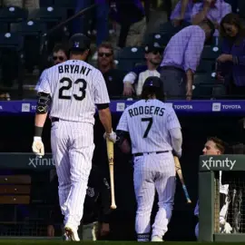  ?? Hyoung Chang, The Denver Post ?? Colorado’s Kris Bryant and Brendan Rodgers leave the field after losing to the Dodgers at Coors Field on Friday.