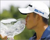  ??  ?? Collin Morikawa kisses his trophy after winning the Workday Charity Open at Muirfield Village. It was Morikawa’s second career victory.