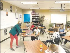  ??  ?? Patricia Myers, an English teacher at Lincoln High School, wore a mask and had her tables spaced out for physical distancing because of covid-19 concern on the first day of school for Lincoln Consolidat­ed School District.