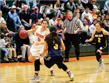  ?? RCORDER PHOTOS BY NAYIRAH DOSU ?? Portervill­e High School's Julia Hunter attempts to dribble past Santa Clara High School's Sofia Maldonado in the first half of Wednesday's CIF State Division V first-round playoff game at Bill Sharman Gymnasium.