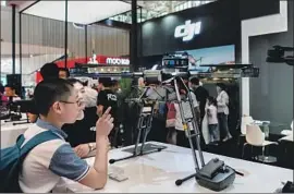  ?? Zhang Peng LightRocke­t ?? DJI of China became the world’s leading drone maker with funding from a venture firm. Above, a DJI drone at a conference in Tianjin, China, last year.