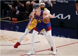  ?? (Isaiah J. Downing/USA Today Sports) ?? DENVER NUGGETS center Nikola Jokic (front) and Los Angeles Lakers forward Anthony Davis both came up big in Game 1 of the Western Conference Finals, with Jokic’s tripledoub­le powering the Nuggets to a 132-126 home victory.