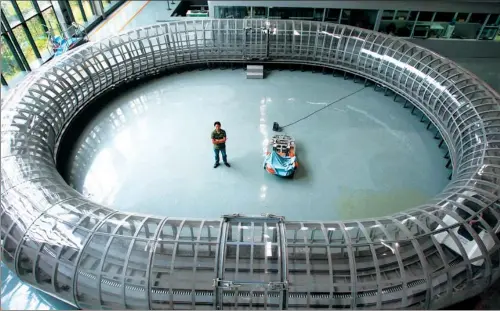  ?? PROVIDED TO CHINA DAILY ?? A scientist surveys a hyperloop used for trials of maglev vehicles at Southwest Jiaotong University in Chengdu, Sichuan province.