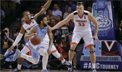  ??  ?? North Carolina guard Joel Berry II (2) drives against Virginia guard Devon Hall and center Jack Salt (33) during the second half of an NCAA college basketball game for the Atlantic Coast Conference men’s tournament title on Saturday, in New York....