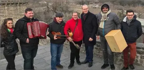  ??  ?? Aidan Lennon and the Upducky Band with Minister for Foreign Affairs, Simon Conveny TD on the Great Wall of China.