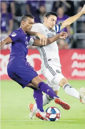  ?? STEPHEN M. DOWELL/ORLANDO SENTINEL ?? Orlando City’s Nani, left, and Philadelph­ia’s Alejandro Bedoya battle for control of the ball during a regular-season game at Exploria Stadium in Orlando on Wednesday night.