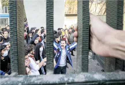  ??  ?? University students attend an anti-government protest inside Tehran University on Dec. 30. (AP)