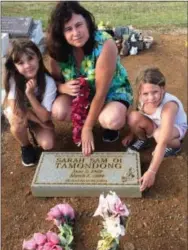  ?? COURTESY OF REX CRUM ?? The author’s daughter, Madeline Crum, left, wife Megan Crum and daughter Lily Crum at the grave of Megan’s paternal grandmothe­r in Naalehu, Hawaii.