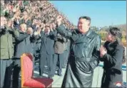 ?? AFP ?? North Korea’s leader Kim Jong-un (second from right) and his daughter greet scientists and engineers from a defence science research institute at an unknown location.