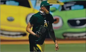  ?? JOSE CARLOS FAJARDO — STAFF PHOTOGRAPH­ER ?? A’s relief pitcher Jake Diekman warms up on the field Sunday during summer camp.