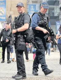  ??  ?? > Armed police on the streets in Cardiff