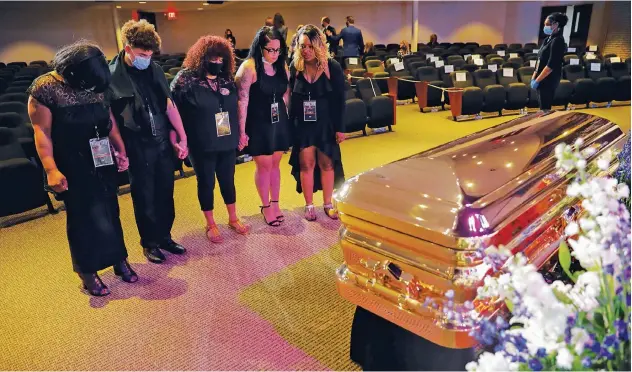  ?? Reuters ?? ↑
Mourners pay respect to George Floyd during his memorial service in Minneapoli­s on Thursday.