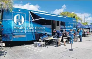  ?? SUSAN STOCKER/SOUTH FLORIDA SUN SENTINEL ?? A mobile unit with the Health Care District of Palm Beach County partners with St. Ann Place Homeless Outreach Center to administer vaccines April 5 in West Palm Beach.