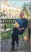  ?? Sophiane Meddour ?? TREES keep author Philippe Besson company as he reads on the balcony of his apartment near Centre Pompidou.