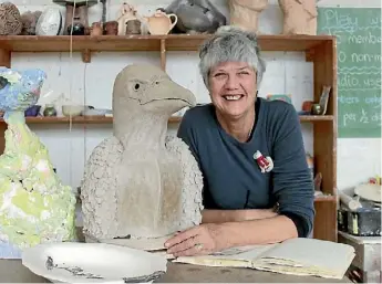  ??  ?? Susan St Lawrence with her clay sculptures that are inspired by stories.