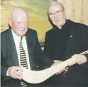  ?? ?? AUTOGRAPHS PLEASE - Captain of the winning 1951 Shanballym­ore County Intermedia­te hurling team, Vincent Fahy along with another of that team’s stars, Fr Denis O’Connor (PP Castletown­roche and Ballyhooly), with the specially autographe­d hurley at the function in the Hibernian
Hotel, Mallow in 2001.