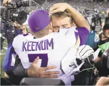  ?? Rob Carr / Getty Images ?? Eagles quarterbac­k Nick Foles and Vikings quarterbac­k Case Keenum embrace after Philadelph­ia’s 34-7 victory.
