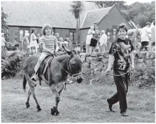  ??  ?? Pictured at the recent Pirnmill Summer Fete: Fiona Laing and Daniel the donkey take Eilidh Kerr for a ride.