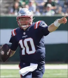  ?? Bill Kostroun / Associated Press ?? New England Patriots quarterbac­k Mac Jones looks to throw during the first half against the New York Jets on Sunday in East Rutherford, N.J.