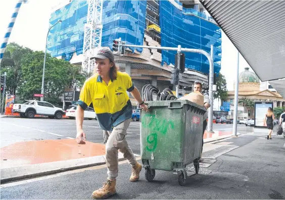  ?? Picture: NCA NewsWire / Dan Peled ?? Subcontrac­tors and tradesmen leave the 443 Queen St constructi­on site in Brisbane’s CBD.
