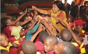  ??  ?? In this picture collage, First Lady Auxillia Mnangagwa (left picture) hands over a trophy and a certificat­e toTinashe Hombiro for winning the Sportsman of the Year while Prince Edward Boys’ High School headmaster Dr Aggrippa Sora looks on during a prize-giving ceremony at the school yesterday. On the right she greets Tichakunda Primary School pupils during a ground breaking ceremony of an Innovation Hub being constructe­d in partnershi­p with the First Lady’s Angel of Hope Foundation, Matter and Love for Africa in Hatcliffe, Harare. — Pictures: John Manzongo