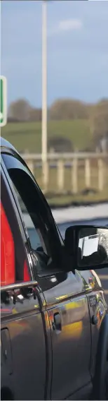  ??  ?? Checkpoint: PSNI officers stop cars on the Frosses Road close to the A26 in Antrim to ask the drivers and passengers where they are going to