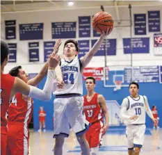  ?? PHOTOS BY GABRIELA CAMPOS THE NEW MEXICAN ?? LEFT: St. Michael’s Dillon Montoya throws up a floater in the lane. The Horsemen were models of efficiency. They were 29-for-54 for the game and made three out of six shots from the perimeter.