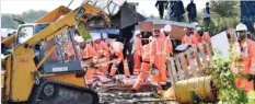  ?? — AFP ?? CALAIS, France: Workers begin the demolition of the Calais “Jungle” camp yesterday as hundreds of migrants boarded buses on the second day of a massive operation to clear the squalid settlement.