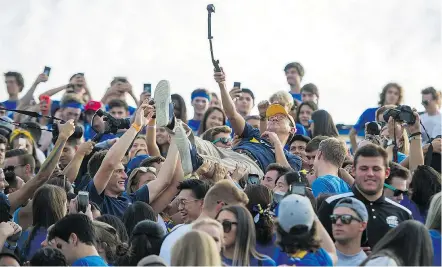  ?? RICH LAM ?? UBC president Santa Ono crowd-surfs during Saturday’s Homecoming Game at Thunderbir­d Stadium. ‘I think (UBC football) is the best kept secret in B.C., probably even in Vancouver,’ said Ono.