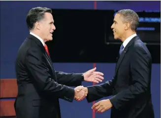  ?? Charlie Neibergall/the Associated Press ?? Republican presidenti­al nominee Mitt Romney and President Barack Obama shake hands before the first presidenti­al debate at the University of Denver, Wednesday, in Denver.