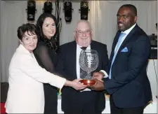  ??  ?? Joseph N’Do presenting the Special Merit Award to Padraig Scanlon, with his daughter Brenda Scanlon and his wife Liz Scanlon. Pics: Carl Brennan.