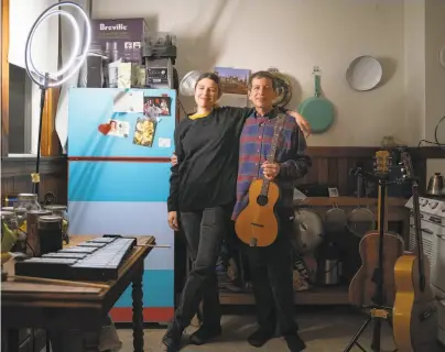  ?? Photos by Sarahbeth Maney / Special to The Chronicle ?? Musicians Meredith Axelrod and Craig Ventresco in their kitchen and makeshift performing studio in North Beach. The duo have performed a mix of vintage blues, rags and pop tunes over live stream nightly for a year.