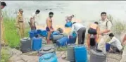  ?? HT PHOTO ?? Videos depicting excise officials dumping the ‘masala’ of the countrymad­e liquor in the Narmada rive were made public which led to the outrage among locals.