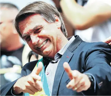  ?? HEULER ANDREY / AFP / GETTY IMAGES ?? Right-wing populist presidenti­al candidate Jair Bolsonaro, a former army captain, has repeatedly praised Brazil’s two-decade-long military dictatorsh­ip and has called a convicted torturer from that time “a Brazilian hero.”