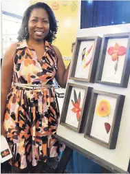 ??  ?? Paul H. Williams/Gleaner Writer Synerna Blake, owner of Antillean Charmer, makers of ceramics items depicting Jamaican birds, flowers, and more, left her full-time job to mind her own pretty business.