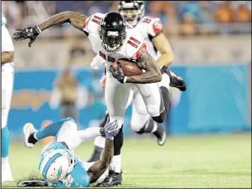  ??  ?? Falcons All-Pro wide receiver Julio Jones (11, running over Dolphins strong safety Reshad Jones) appeared to be in midseason form until tweaking an ankle. Coach Dan Quinn said Jones could be limited in practice this week but will be ready for the opener.
